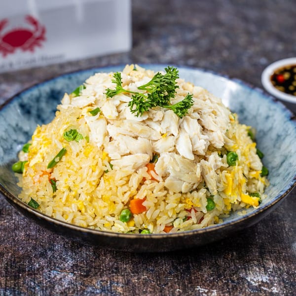 The Roasted Crab's crab fried rice, topped with large flakes of crab meat and parsley.